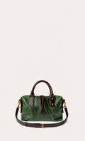 A green textured leather handbag with dark brown leather handles, straps, and tassel detail, accented with gold-tone hardware, shown against a solid off-white background.