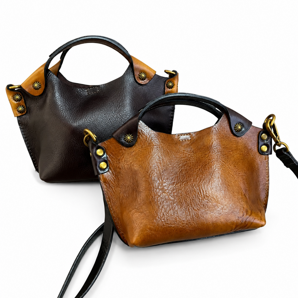 Two leather handbags, one brown and one black, on a white background