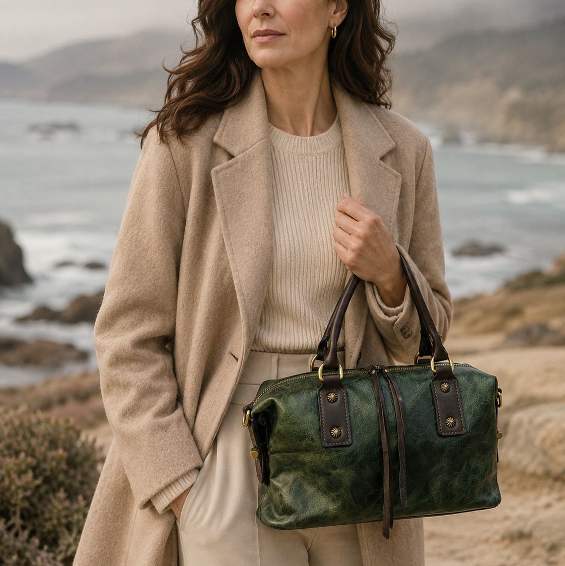 Woman holding a green handbag by the coast